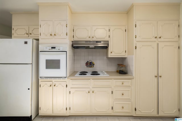 kitchen with backsplash, crown molding, light tile patterned flooring, and white appliances