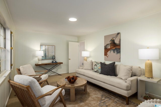 living room with crown molding and carpet