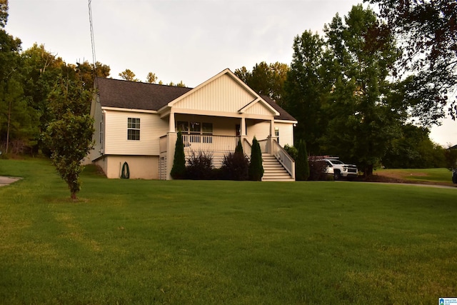 exterior space featuring covered porch and a front yard