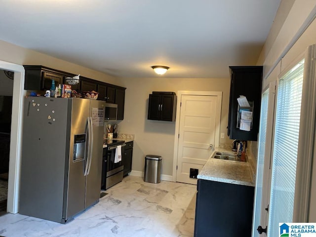 kitchen with dark brown cabinets, stainless steel appliances, and sink