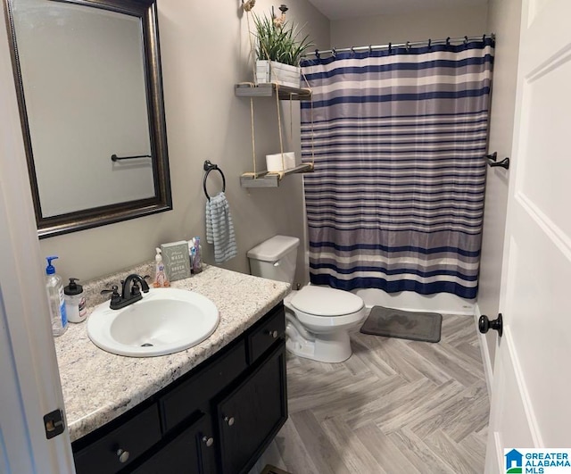 bathroom featuring walk in shower, toilet, vanity, and parquet flooring