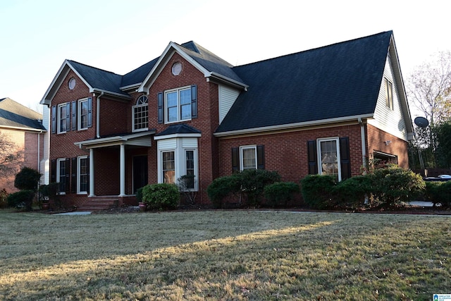 front facade with covered porch, a garage, and a front yard