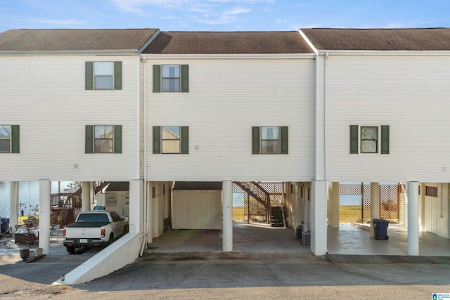 rear view of property with a carport