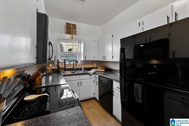 kitchen featuring white cabinetry, sink, black appliances, and light hardwood / wood-style flooring