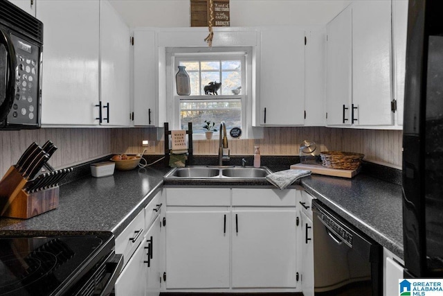 kitchen with dishwasher, white cabinetry, and sink