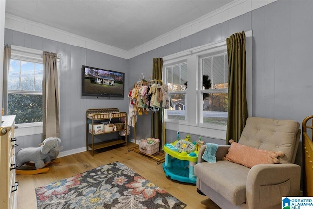 sitting room featuring ornamental molding and light hardwood / wood-style flooring