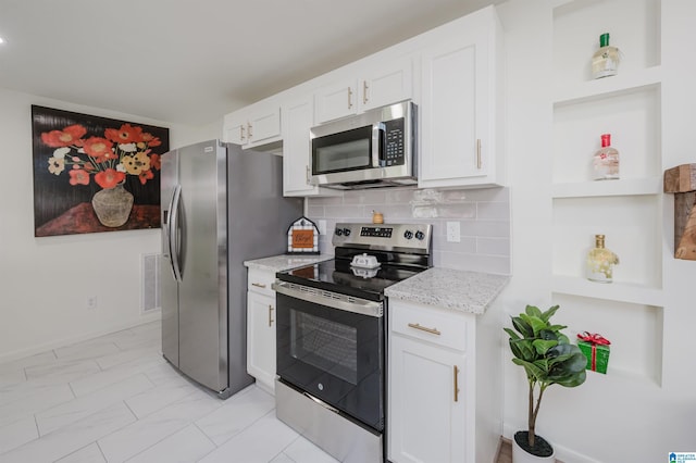 7321 Naples Ave, Birmingham, AL 35206 - kitchen featuring appliances with stainless steel finishes, open shelves, white cabinetry, light stone counters, and light marble finish floors