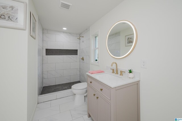 7321 Naples Ave, Birmingham, AL 35206 - full bath featuring toilet, marble look tile flooring, vanity, tiled shower, and recessed lighting