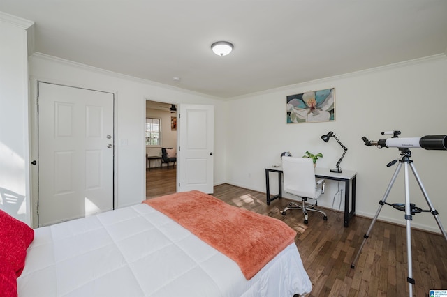 bedroom featuring ornamental molding and dark wood-type flooring