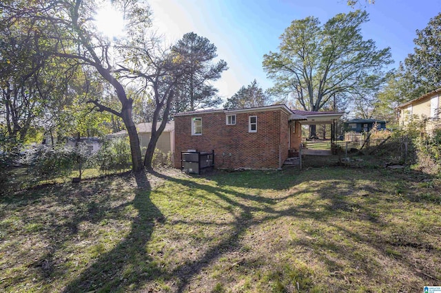 back of house featuring a lawn