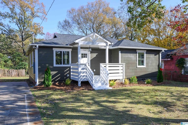 bungalow-style house featuring a front yard