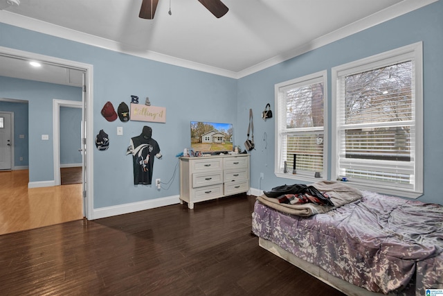 bedroom featuring ceiling fan, dark hardwood / wood-style floors, and crown molding