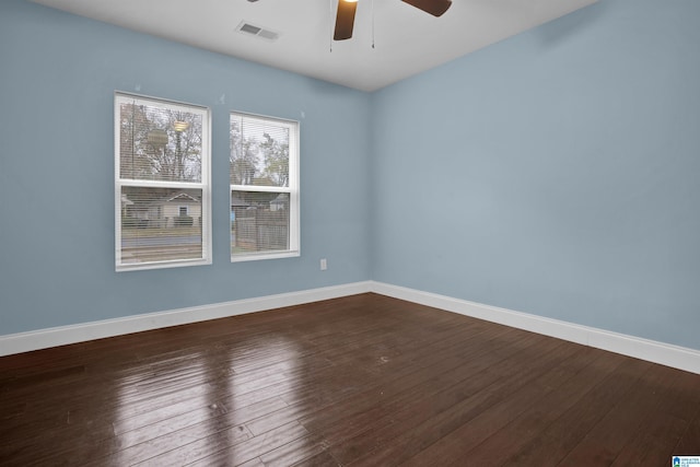 unfurnished room featuring ceiling fan and dark hardwood / wood-style flooring