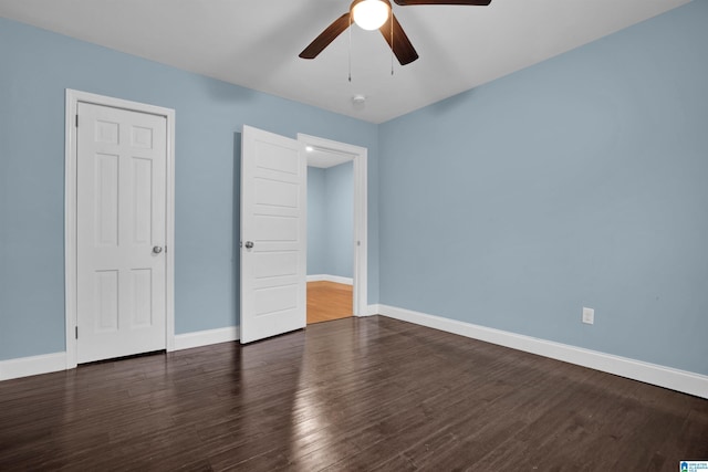 unfurnished bedroom featuring dark hardwood / wood-style floors and ceiling fan