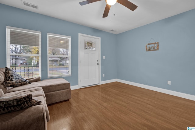 living room featuring ceiling fan and hardwood / wood-style floors