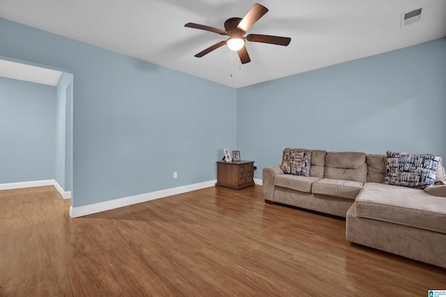 unfurnished living room with ceiling fan and hardwood / wood-style floors