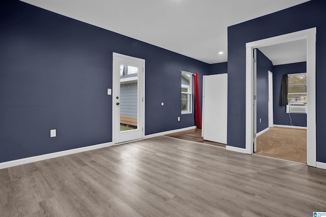 interior space featuring cooling unit and light hardwood / wood-style flooring