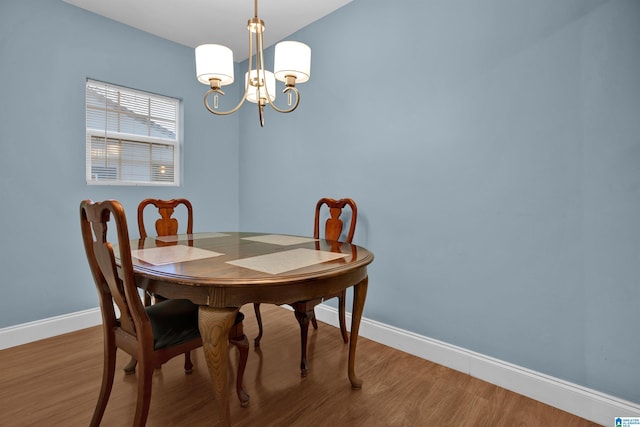 dining room featuring hardwood / wood-style flooring and a notable chandelier