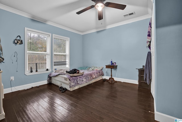 bedroom with dark hardwood / wood-style floors, ceiling fan, and crown molding