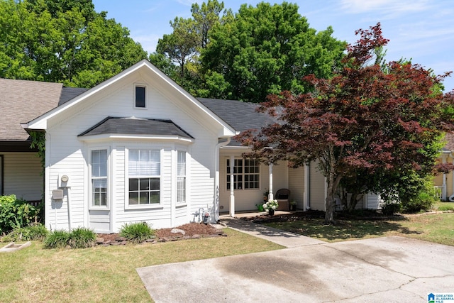 bungalow-style home with a front yard