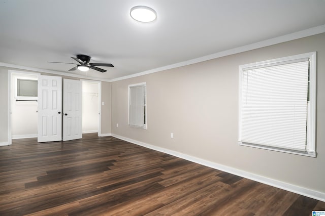 unfurnished bedroom with ceiling fan, dark hardwood / wood-style flooring, and crown molding