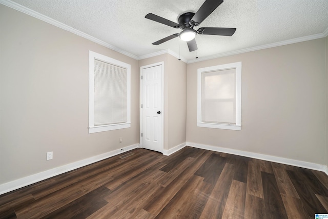 empty room with a textured ceiling, dark hardwood / wood-style floors, and crown molding