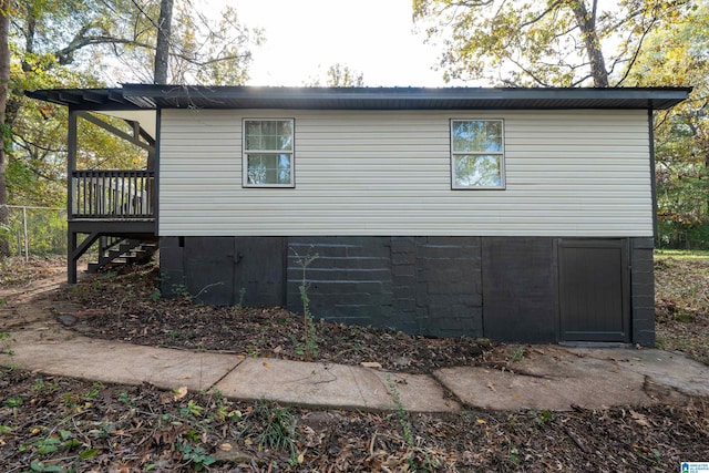 view of side of property with a wooden deck