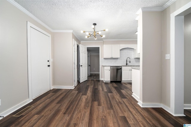 kitchen with dishwasher, dark hardwood / wood-style floors, white cabinetry, and ornamental molding