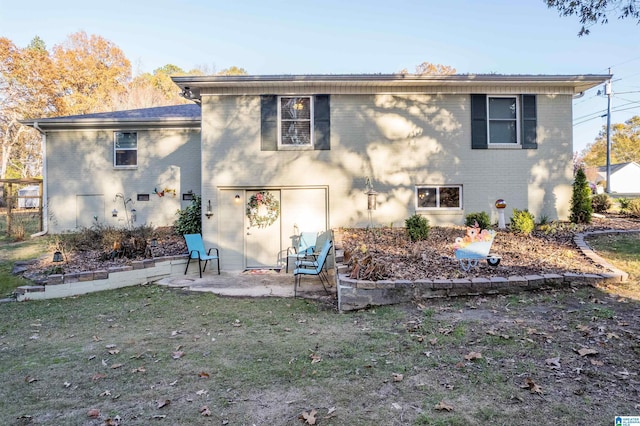 back of house with a lawn and a patio area