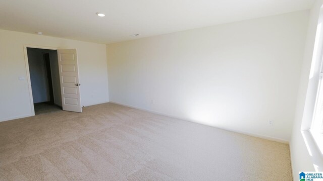 unfurnished room with light carpet