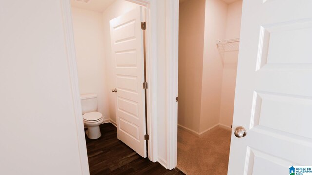 bathroom with wood-type flooring and toilet