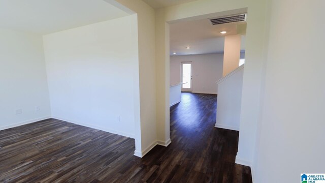 corridor featuring dark hardwood / wood-style flooring