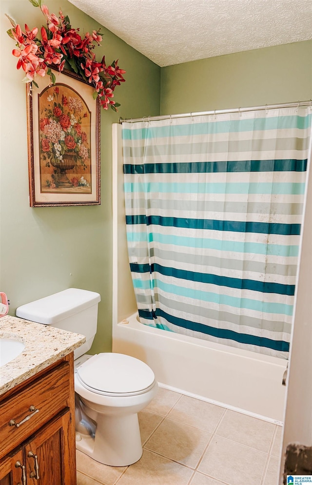 full bathroom with tile patterned floors, vanity, a textured ceiling, shower / bath combo with shower curtain, and toilet