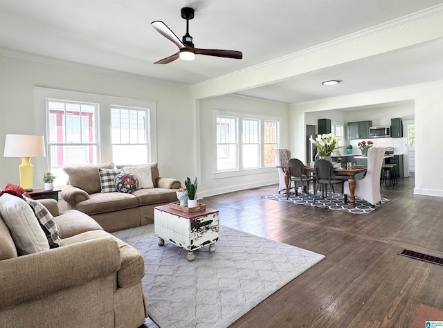 living room with dark hardwood / wood-style floors, ceiling fan, and ornamental molding