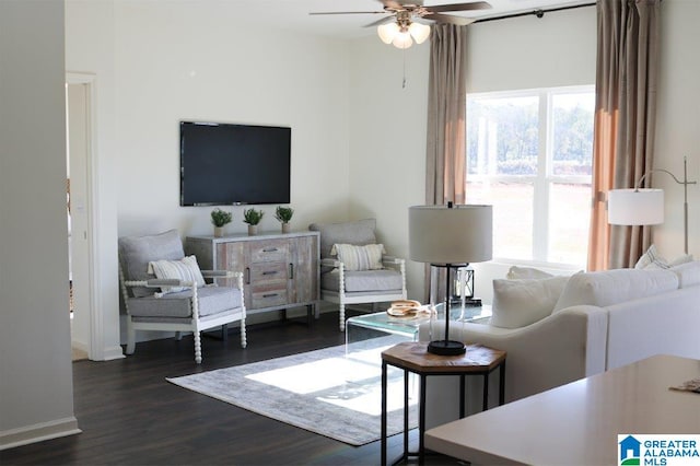 living room featuring ceiling fan and dark wood-type flooring