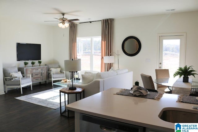 living room featuring ceiling fan and dark wood-type flooring