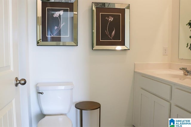 bathroom with vanity and toilet