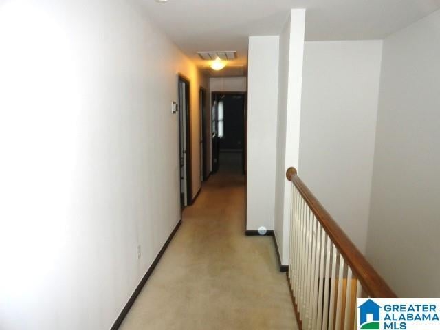 hallway featuring light colored carpet