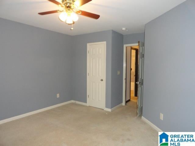 unfurnished bedroom featuring ceiling fan and light colored carpet