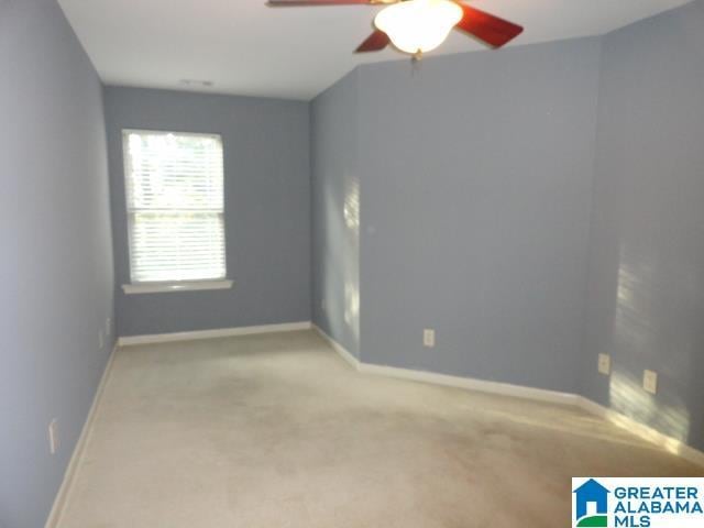 unfurnished room featuring light carpet and ceiling fan