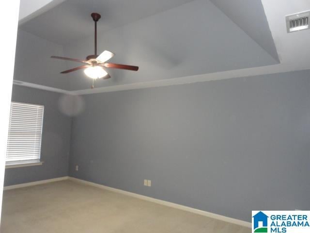 carpeted spare room with ceiling fan