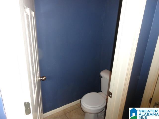 bathroom with tile patterned flooring and toilet