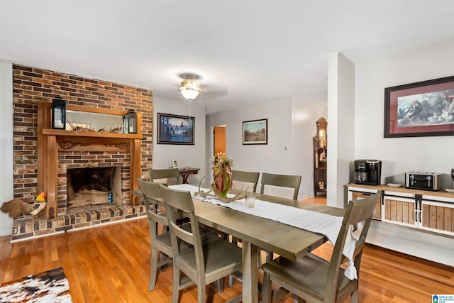 dining space featuring light hardwood / wood-style floors and a fireplace