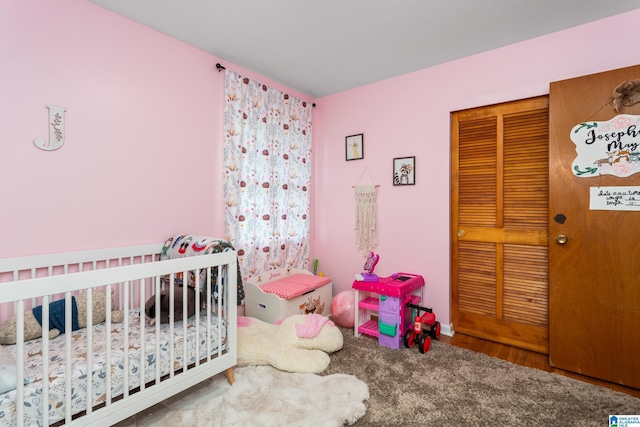 carpeted bedroom featuring a crib