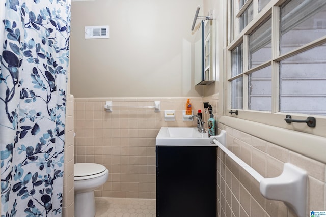 bathroom with tile patterned flooring, vanity, tile walls, and a shower with shower curtain