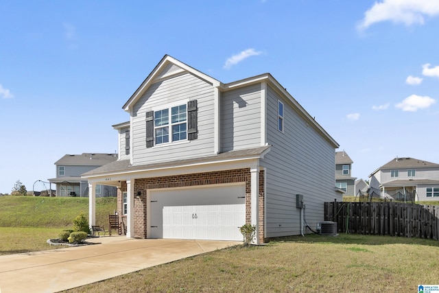 view of front of home with central AC, a front lawn, and a garage