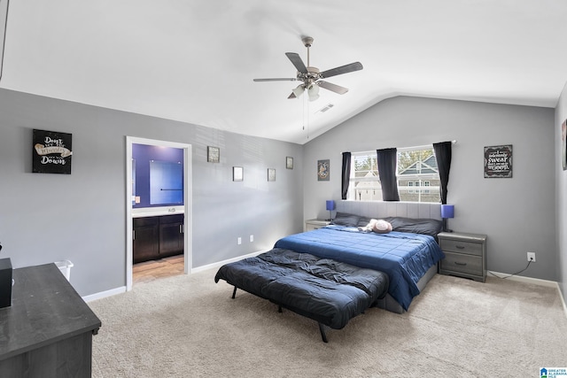 bedroom with light colored carpet, ensuite bath, ceiling fan, and lofted ceiling