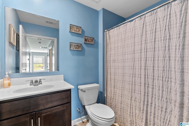 bathroom featuring vanity, toilet, and curtained shower