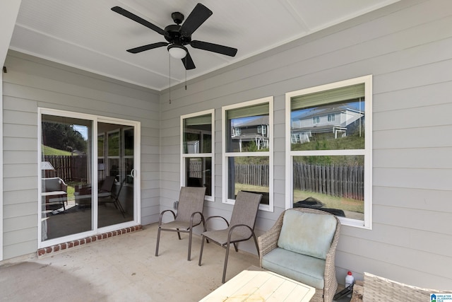 unfurnished sunroom featuring a wealth of natural light and ceiling fan