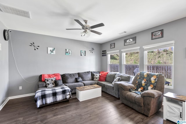 living room featuring dark hardwood / wood-style flooring and ceiling fan